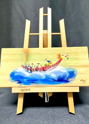Beautiful painting of a dragon boat on the waves, painted on a wooden panel on a wooden easel